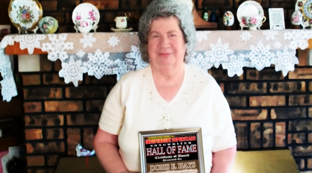 Doris E. Hays holding the Hall Of Fame Award she recently received in the post